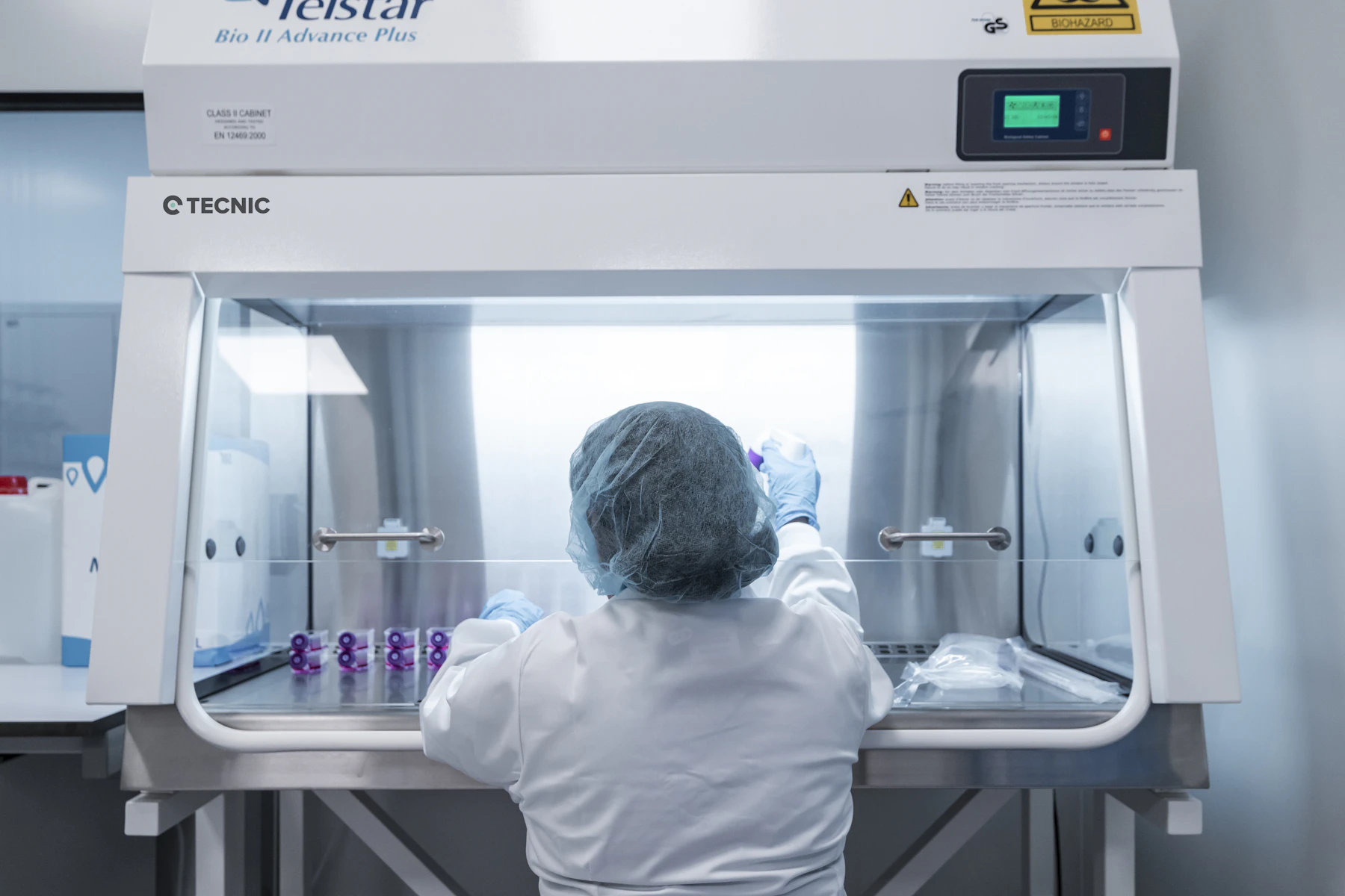 Quality-control specialist working in a controlled laboratory environment